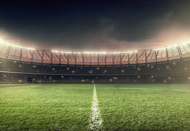 soccer field with illumination and night sky soccer stadium with illumination, green grass and dramatic night sky grass family photos stock pictures, royalty-free photos & images