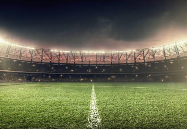 soccer field with illumination and night sky soccer stadium with illumination, green grass and dramatic night sky stadium stock pictures, royalty-free photos & images