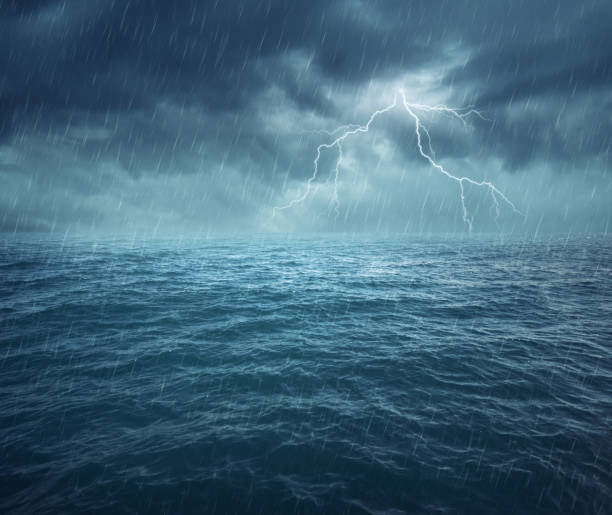 Image of night stormy sea with big waves and lightning stock photo