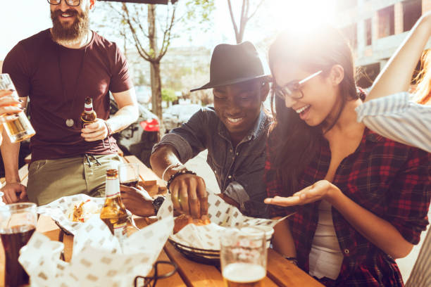 istock friends eating outdoors on a picnic 693255648