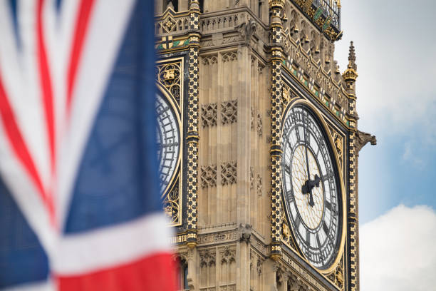 istock Union Jack fluttering in the wind with Big Ben in the background 693255678