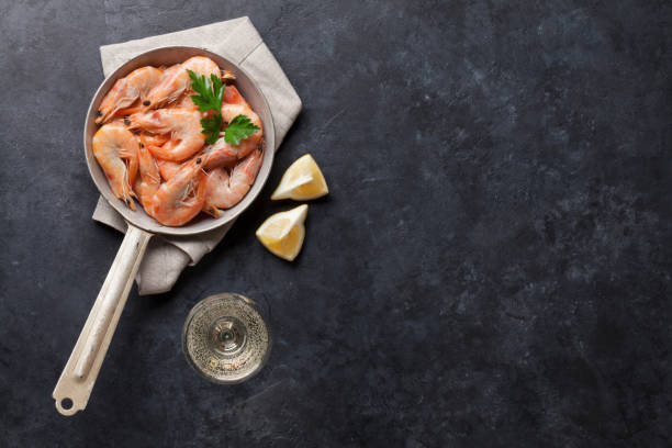 istock Fresh seafood on stone table. Shrimps 693256512