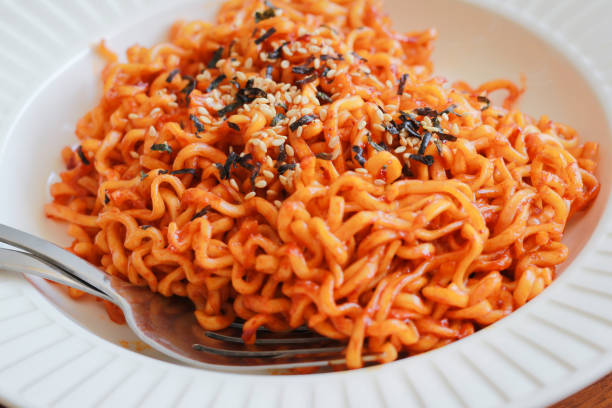 istock Spicy noodles sprinkle sesame seeds. 693259180