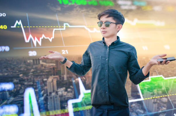 istock Young business man using laptop and digital tablet cityscape background 693272910
