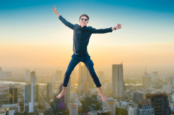 istock Young business man using laptop and digital tablet cityscape background 693273002
