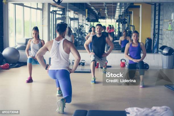 Group Of People Workout In Healthy Club Young People Stretching For Legs Stock Photo - Download Image Now