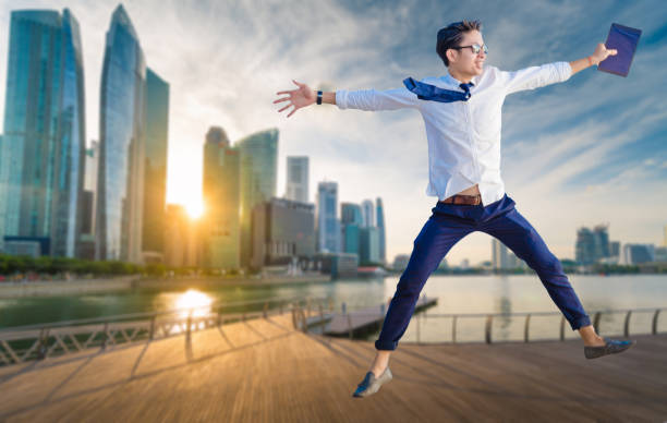 istock Asian business man using laptop and digital tablet in Singapore 693273380