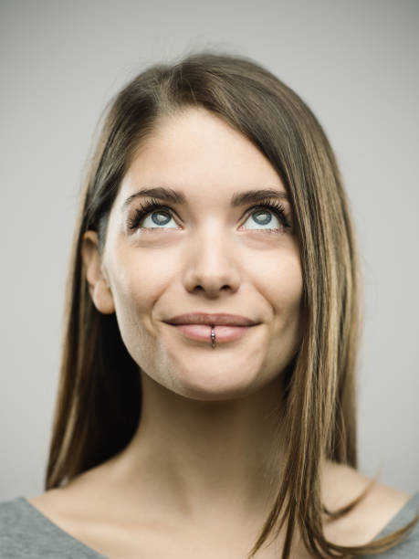 istock Real happy young woman studio portrait looking up 693273558