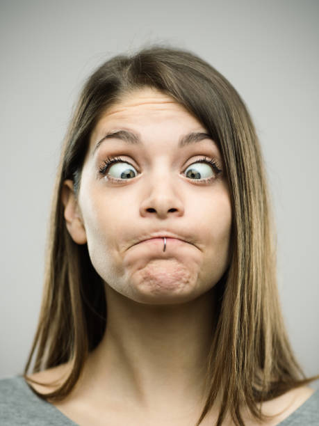 istock Real young woman grimacing with crossed eyes 693273628