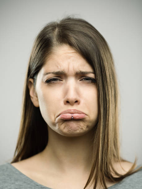 istock Real young woman portrait with depressed expression 693273676