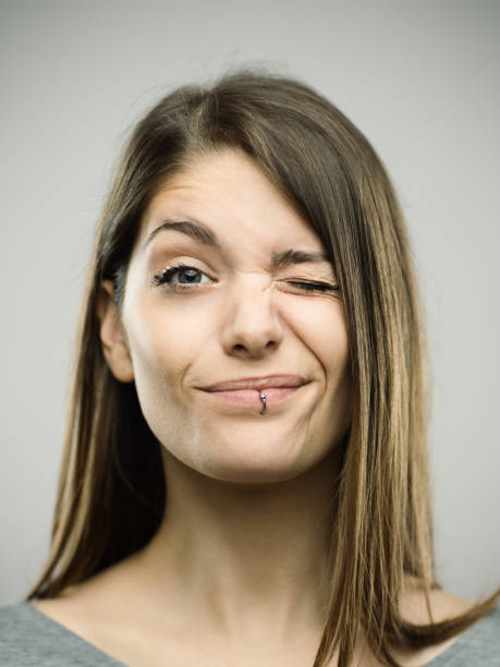 istock Real young woman winking 693273928