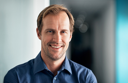 Portrait of smiling male entrepreneur with eyeglasses looking at camera.