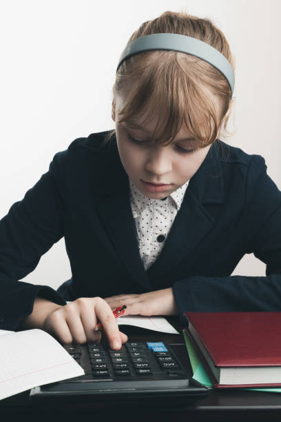 istock School girl using calculator, closeup portrait 693277438