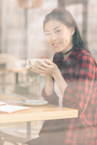 istock attractive asian girl drinking coffee in cafe, coffee break concept 693278152
