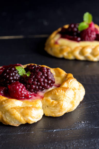 istock Vanilla Cream and Fruit Berry Puff Pastry Dessert on Dark Background 693278596