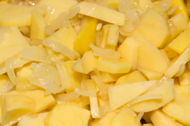 istock potatoes and onions in a frying pan as background 693279808