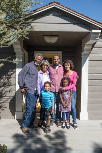 istock Three generation family outside house 693289850