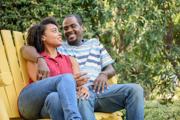 istock Cheerful African American couple on bench, smiling 693290224