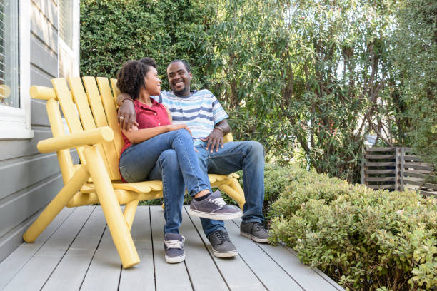 istock Affectionate young couple sitting on yellow bench in garden 693290226