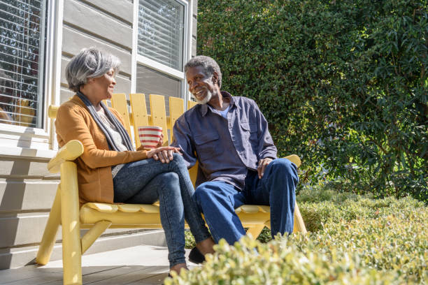 istock Senior African American couple sitting on bench talking 693290282