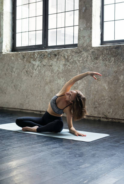 istock Young woman practicing yoga in urban studio 693293998