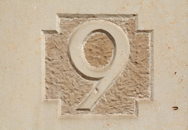 istock Old, brown house number plate on brown house wall 693297984