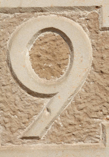 istock Old, brown house number plate on brown house wall 693297998