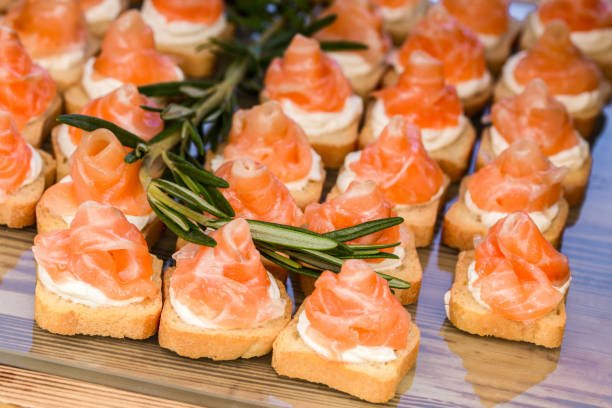 istock mini canapes with smoked salmon and rosemary sprig. 693298272