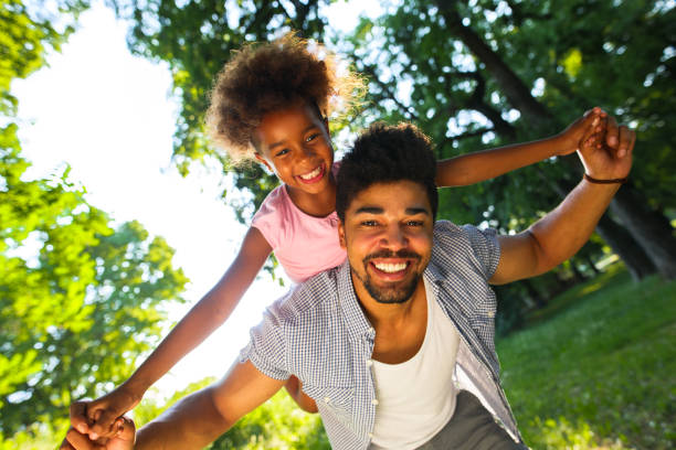 istock Smiling father giving his daughter piggyback ride. 693298284