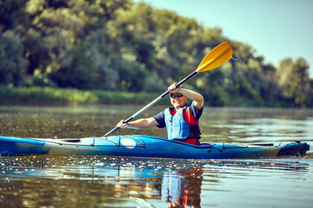 istock Man paddling a kayak on summer day. 693303524