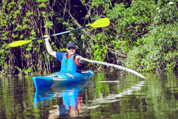 istock Man paddling a kayak on summer day. 693303534