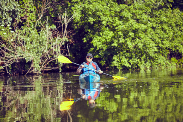 istock Man paddling a kayak on summer day. 693303560