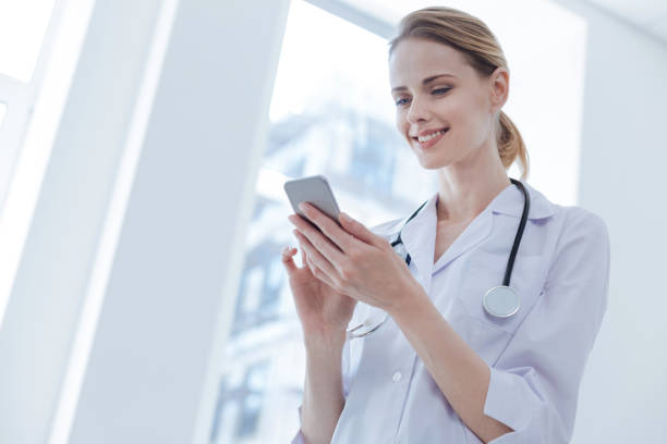 istock Charismatic therapist using digital gadget in the clinic 693304220