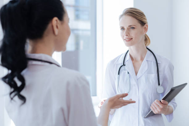 istock Sociable medical colleagues enjoying conversation at work 693307434