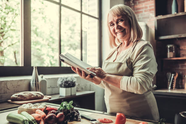 istock Old woman in kitchen 693307884