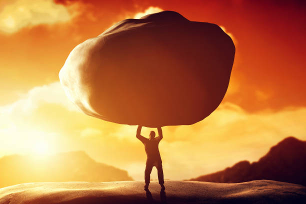 Man lifting a huge rock. Concept of strength, ballast, difficulty, power