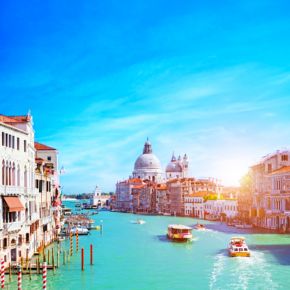 Venice, Italy. Grand Canal and the Salute at sunny day. Tourist boats View from Ponte dell Accademia