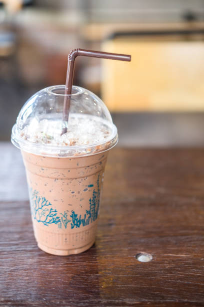 istock Iced chocolate in takeaway cup on wooden table 693318876
