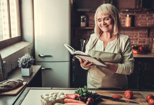istock Old woman in kitchen 693321654