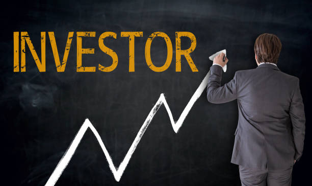 istock Businessman writes investor on blackboard concept 693323200