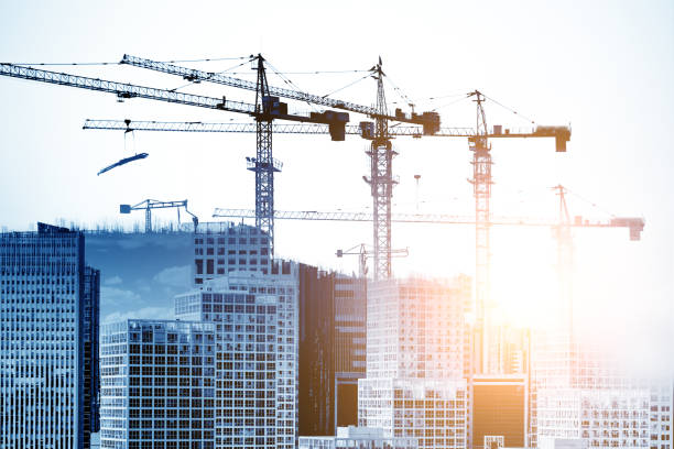 istock Double exposure of construction crane with city 693323252