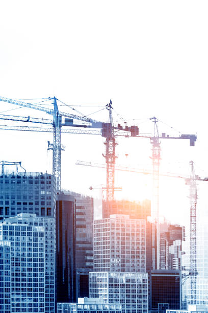 istock Double exposure of construction crane with city 693323766