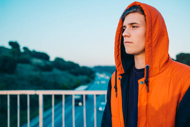 istock Casual young man by the highway 693332410