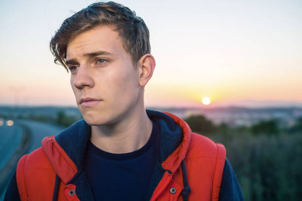 istock Casual young man by the highway 693332534