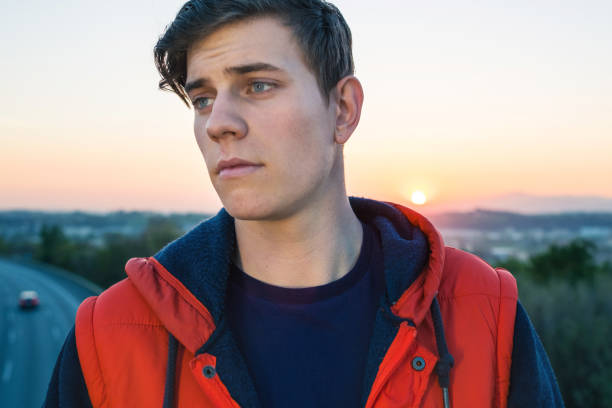 istock Casual young man by the highway 693332690