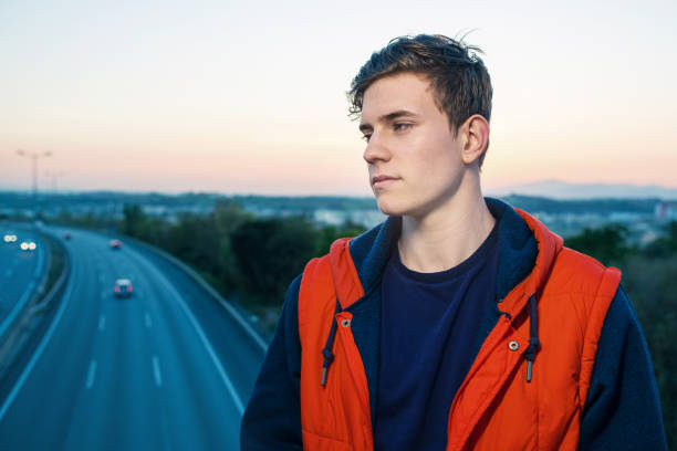 istock Casual young man by the highway 693335654
