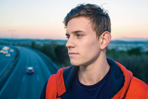 istock Casual young man by the highway 693335766