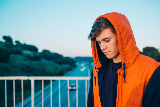 istock Casual young man by the highway 693335864
