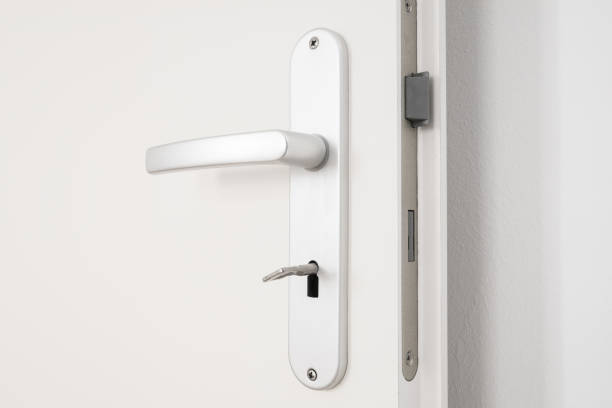istock metallic door handle with key on white door 693336082