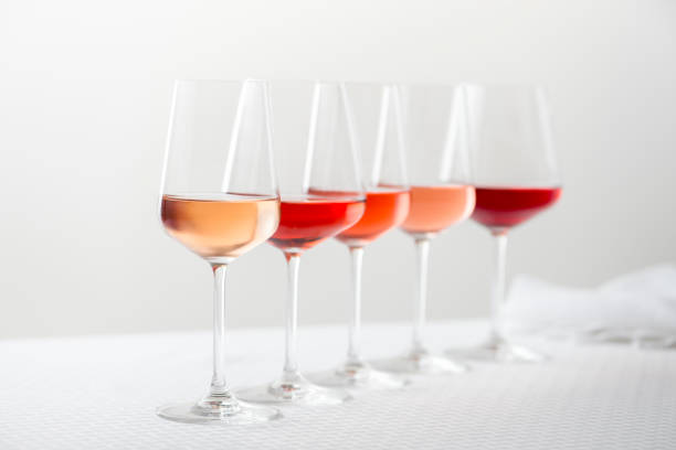 Grouping of five varieties of rose wine in wineglasses in a row.